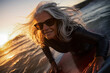 © ADDICTIVE STOCK - Generative AI image of joyous surfer mature woman catching waves at sunset