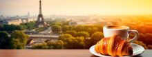 A Cup Of Coffee And A Croissant With The Eiffel Tower In The Background. Selective Focus.