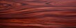 Amazon Rosewood Dalbergia spruceana wood texture and merterials background. Rare and expensive wood reddish-brown color with darker streaks texture background