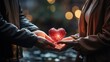 Two people hand over small heart in each other hands