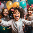 Happy children celebrating a birthday with confetti and balloons.