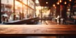 Wooden surface foregrounds a softly defocused café interior