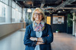 © okrasiuk - Portrait of smiling 50's stylish, confident mature businesswoman, middle aged company ceo director, experienced senior female professional, business coach team leader in modern office. Female leader.