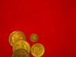 Spanish gold and silver coins, Shields and Reales, on a red background