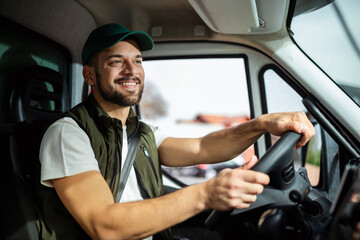 Wall Mural - Young handsome man working in towing service and driving his truck.