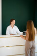 © fesenko - Client of the beauty salon pays with a phone using NFC contactless payment.