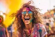 Portrait of smiling young woman wearing sunglasses covered with holi color