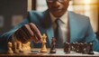  Businessman moving chess piece on chess board game