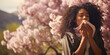 Allergic african woman blowing on handkerchief in park or garden on spring season on sunny day outside