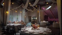 A Beautifully Decorated Wedding Reception Venue. A Room With Tables And Chairs, Flower Decoration. Luxury Event.