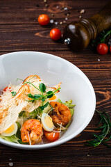 Canvas Print - Caesar salad with shrimps, parmesan cheese, eggs, lettuce, tomatoes and croutons, Italian lunch.