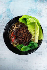 Wall Mural - Noodle soup, minced pork, chili, lettuce and spinach, fresh lunch.