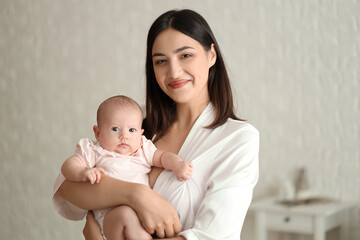 Poster - Young woman with her baby in bedroom