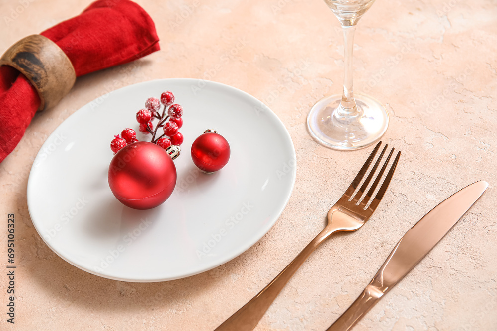 Festive table setting with Christmas decorations on beige grunge background, closeup