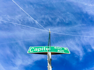 Capitol Avenue Street Sign. Looking up at a green street crossing sign that says, 