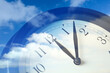 © New Africa - Time concept. Double exposure of blue sky with fluffy clouds and clock