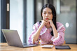 © David - Portrait of tired young business Asian woman work with documents tax laptop computer in office. Sad, unhappy, Worried, Depression, or employee life stress concept