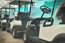 New golf carts parked in parallel and ready for delivery