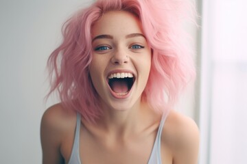 Wall Mural - A woman with pink hair is captured in a moment of laughter as she looks directly at the camera. This image can be used to portray joy, happiness, and individuality.