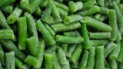 Wall Mural - Frozen green beans close up, rotation. Healthy vegan food concept