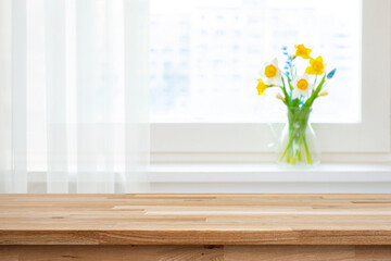 Wall Mural - empty wooden table top for product montage and blur window sill with beautiful flowers