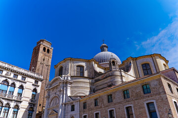 Scenic view of the brick wall church tower of church Santi Geremia e Lucia and historic buildings on a cloudy summer day. Photo taken August 6th, 2023, Venice, Italy.