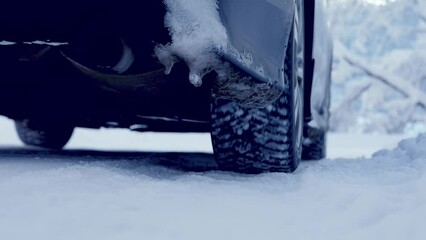 Wall Mural - Car driving on the winter road in snowy forest. Concept of family vacation, trip and holidays.