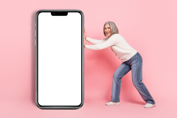 Wall Mural - Full body photo of gorgeous mature grandma push telephone screen display dressed stylish white outfit isolated on pink color background