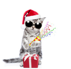 Aufkleber - Cool kitten wearing red santa hat and sunglasses stands with gift box  and holds exploding firecracker. Isolated on white background