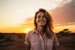 Portrait of a happy woman in her 30s wearing a simple cotton shirt against a vibrant sunset horizon. AI Generation