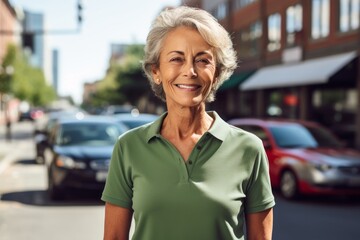 Wall Mural - Portrait of a grinning woman in her 60s wearing a breathable golf polo against a busy urban street. AI Generation