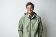 © Markus Schröder - Portrait of a grinning man in his 30s wearing a lightweight packable anorak against a modern minimalist interior. AI Generation