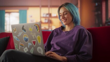 Poster - Young Attractive Woman Working from Home on Laptop Computer with Stickers in Cozy Stylish Loft Apartment. Creative Female Smiling, Checking Social Media, Browsing Internet