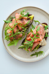 Canvas Print - Rye toast with smoked salmon, avocado, hollandaise sauce and arugula.