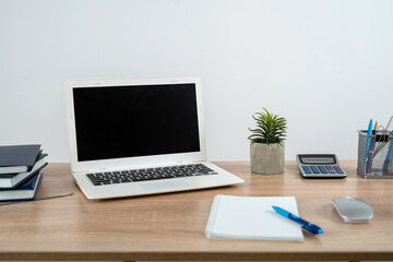 Empty notepad with pen laptop calculator coffee on a office wooden surface, nobody.