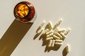 Wall Mural - Jar with pills on a white background. View from above. Morning routine