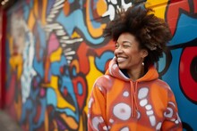 Portrait Of A Blissful Afro-american Woman In Her 40s Dressed In A Comfy Fleece Pullover Against A Vibrant Graffiti Wall. AI Generation