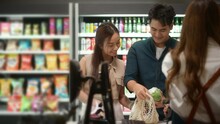 An Asian Couple Shopping In Supermarket , Concept Of City Life Lifestyle