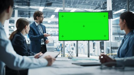 Poster - Electronics Factory Office Meeting: Caucasian Male CEO Presenting Innovative High-Tech Device On TV With Green Screen Chromakey. Diverse Engineers And Technicians Listening, Planning Production.