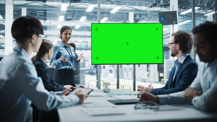 Poster - Electronics Factory Office Meeting: Hispanic Female Project Manager Presenting Innovative High-Tech Device On TV With Green Screen Chromakey. Diverse Engineers And Technicians Listening, Taking Notes.