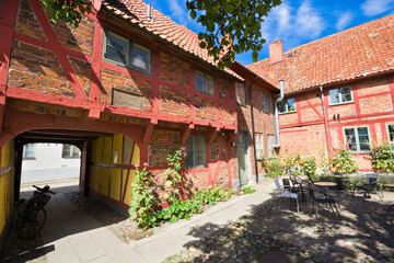 Sticker - Lovely courtyard of half-timbered building of Helsa Farm in Ystad, Sweden