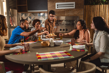 Young man serving his guests at the table.