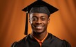 © hakule - smiling African American graduate man in a cap and gown