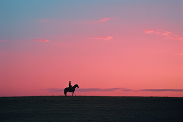 Poster - Minimalist portrayal of a cowboy's peaceful ride in a twilight landscape.