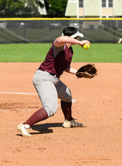 Wall Mural - Girls softball players making athletic plays, throwing, sliding and catching the ball during a game