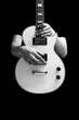 © princeoflove - BW male musician posing on white electric guitar, isolated on black. music background