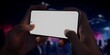 © ivanbaranov - Caucasian man holding phone, night club in the background, blank screen mockup