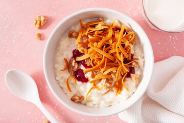 Wall Mural - rice pudding with Norwegian brunost traditional brown cheese and raspberry jam