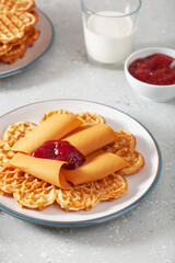 Wall Mural - waffles with Norwegian brunost traditional brown cheese and raspberry jam