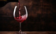 Poring red wine in a glass on dark background. Red wine is poured into a glass from a bottle